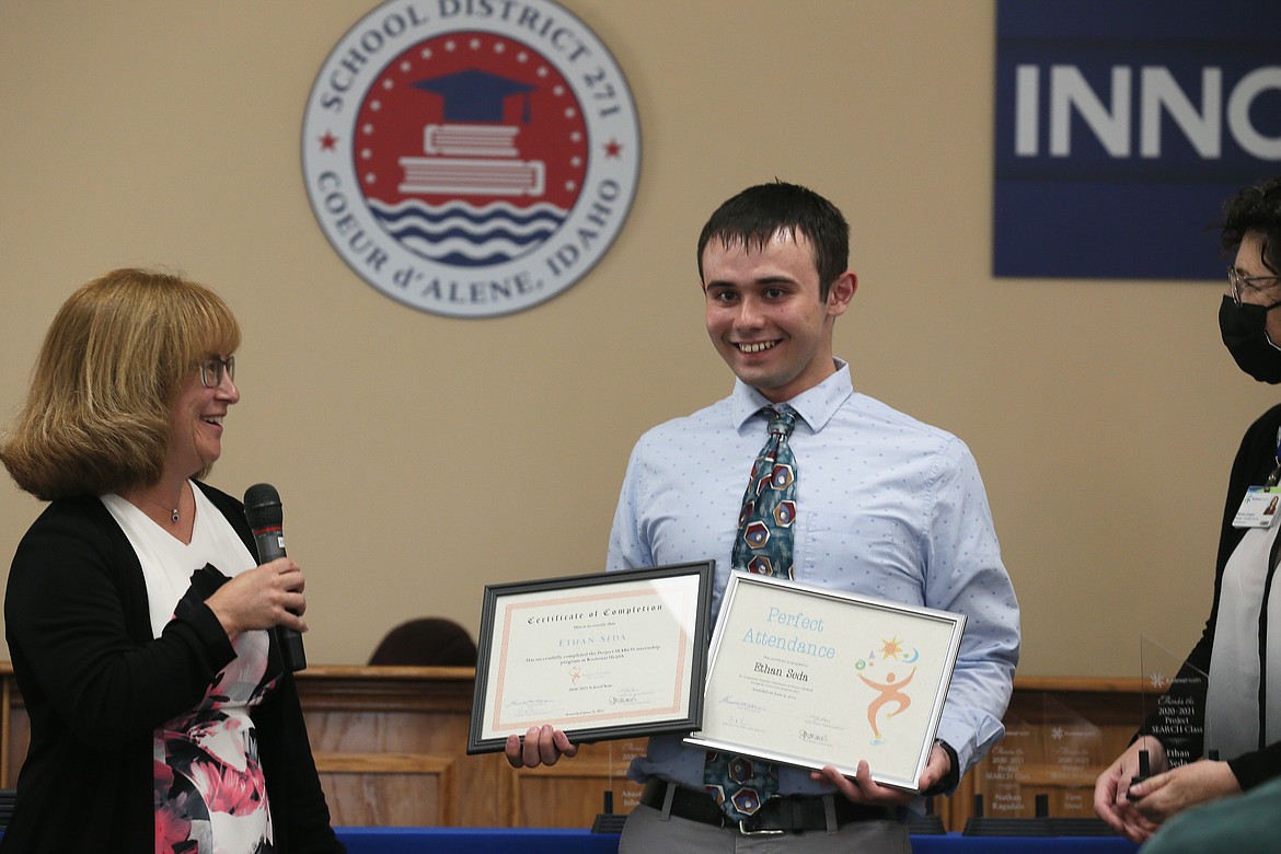 Project SEARCH grad Ethan Seda is all smiles as he receives his certificate of completion and an award for perfect attendance during the graduation celebration Wednesday. Also pictured: Project SEARCH instructor Theresa Moran, left, and Kootenai Health business liaison Renee Langue.