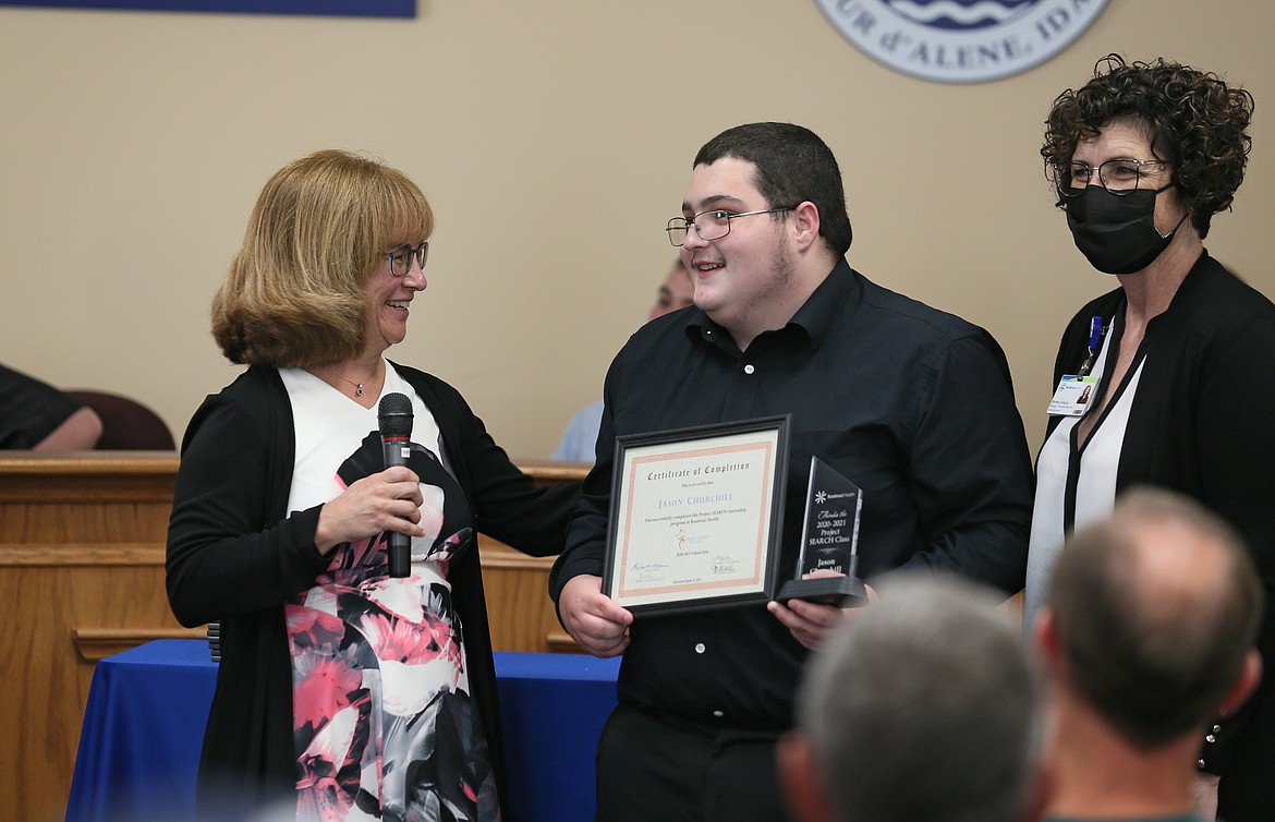 Project SEARCH instructor Theresa Moran, left, and Kootenai Health business liaison Renee Langue congratulate graduate Jason Churchill on Wednesday as he receives his certificate of completion.