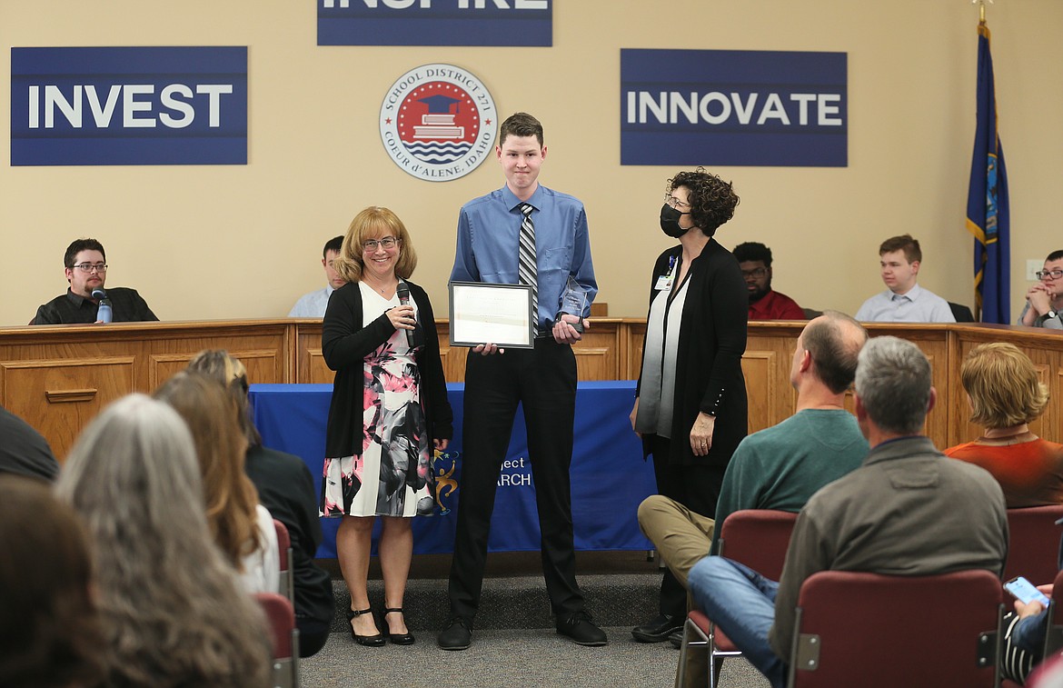 Zion Stout, center, receives his certificate of completion from Project SEARCH instructor Theresa Moran, left, and Kootenai Health business liaison Renee Langue on Wednesday.
