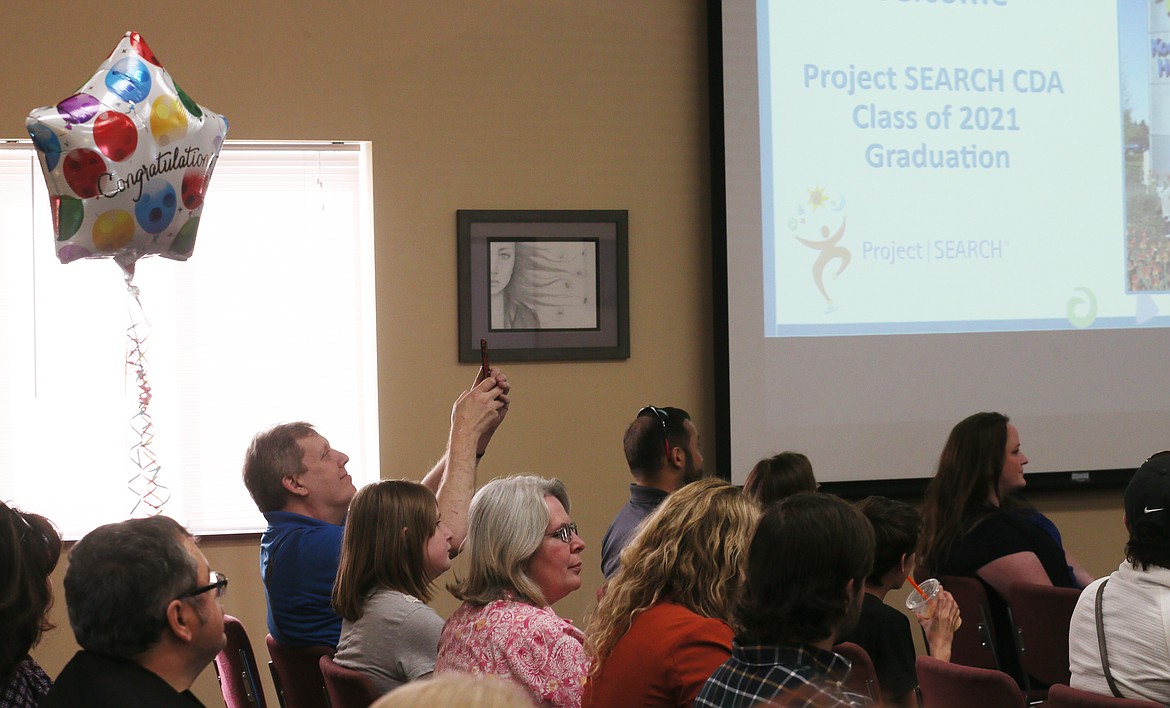 A proud dad takes a photo of the Project SEARCH graduating class of 2021 during a celebration in Midtown Meeting Center on Wednesday.