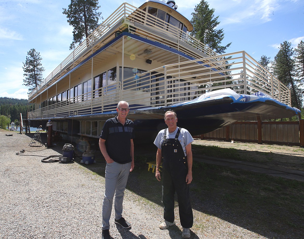 Craig Brosenne, president of the Hagadone Marine Group, and Fred Finney, owner of Finney Boat Works, stand in front of the Coeur d'Alene that is undergoing improvements.