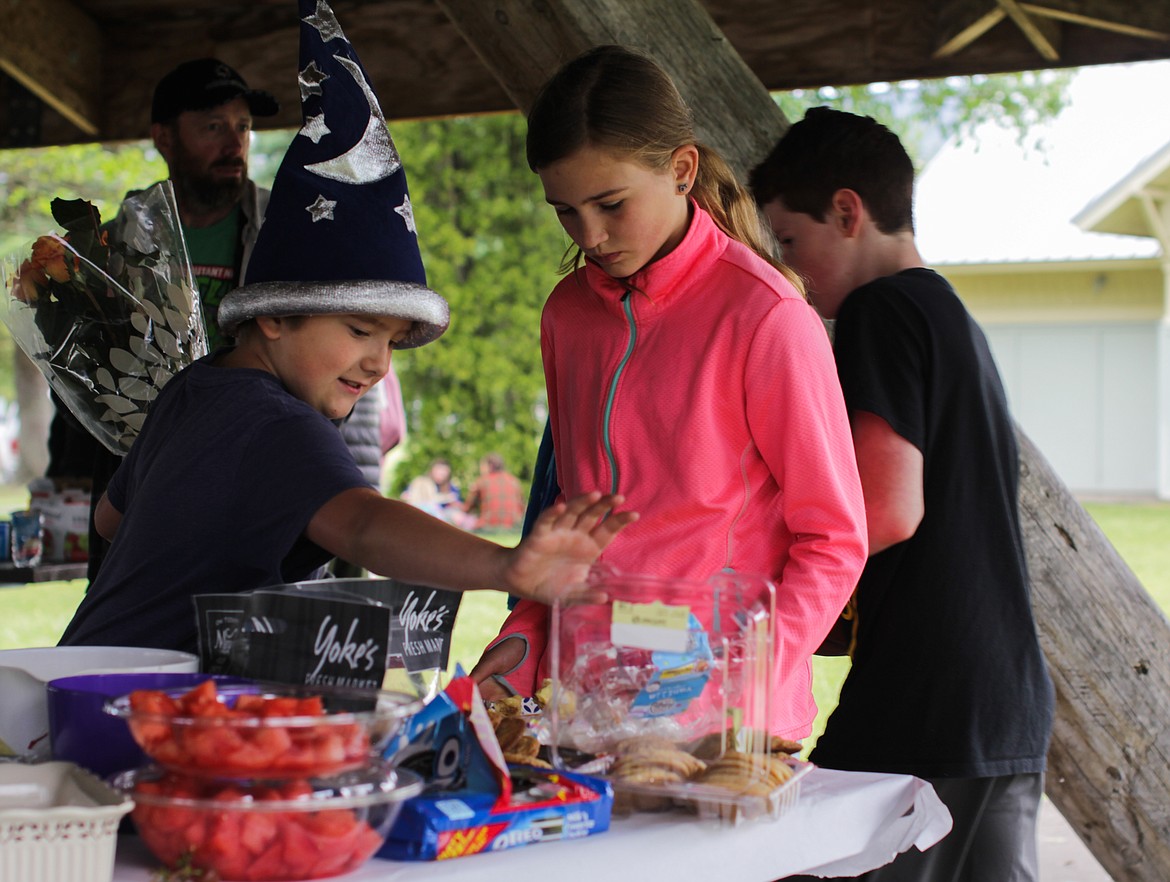 Students at the Homeschool Academy  help themselves to snacks at the annual party at City Beach on Friday.
