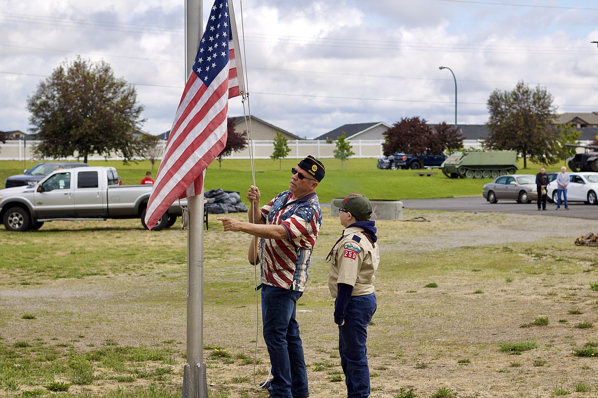 HANNAH NEFF/Press
Sergent-at-Arms Tim Shaw directs Cub Scout Pack 250 scout Tristan Cord in lowering the flag at the flag day ceremony Saturday morning at the American Legion post in Post Falls