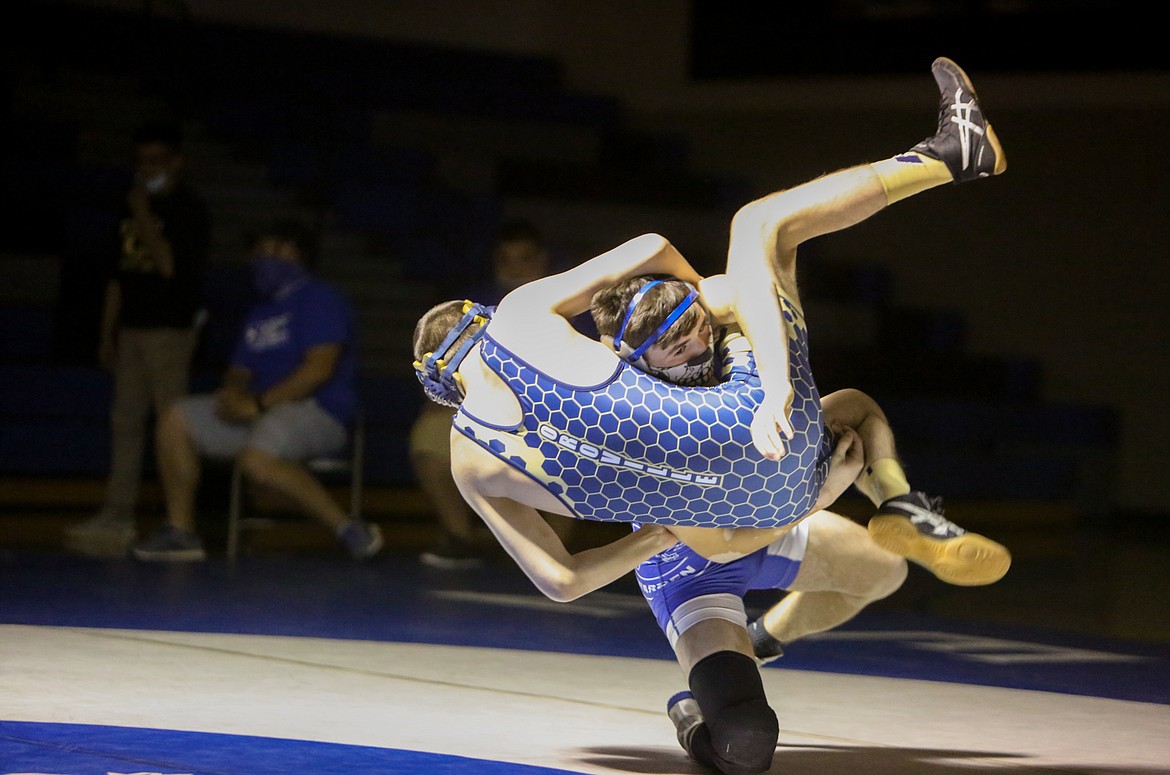 Warden High School senior Rolando Martinez takes his opponent, Justin Kaufman of Oroville High School, to the mat with a slam in the final match of the afternoon at Warden High School on Saturday.