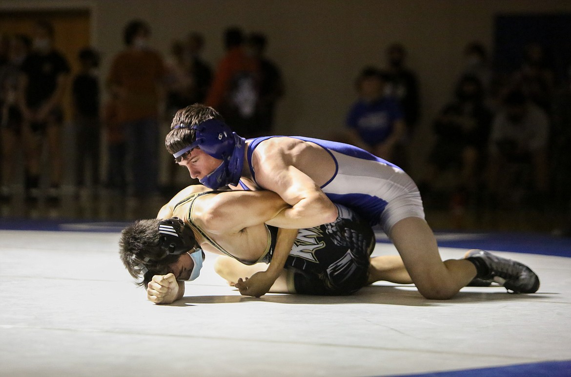 Warden's Cael Cox looks to flip his opponent, Royal High School's Vidal Abundiz, to his back for the pin on Saturday afternoon at Warden High School.