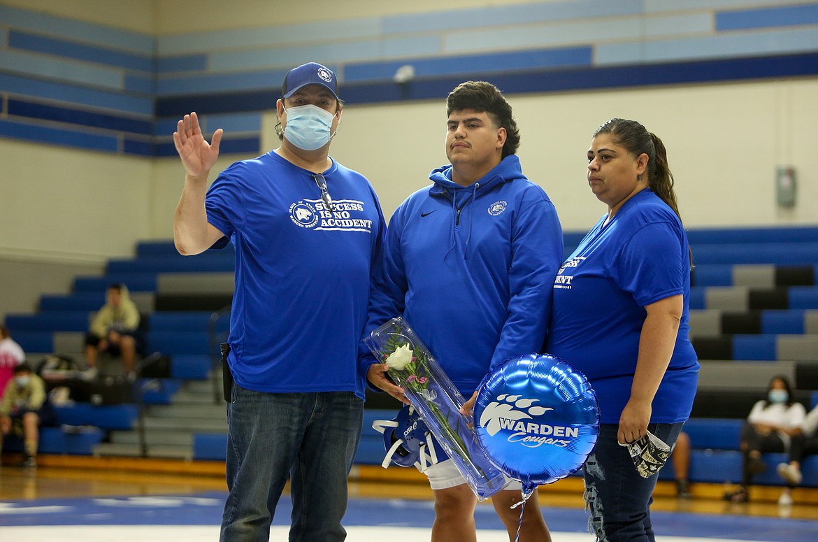 Warden High School senior Zeke Guerra is honored alongside his parents before the mix 'n' match dual event in Warden on Saturday afternoon.