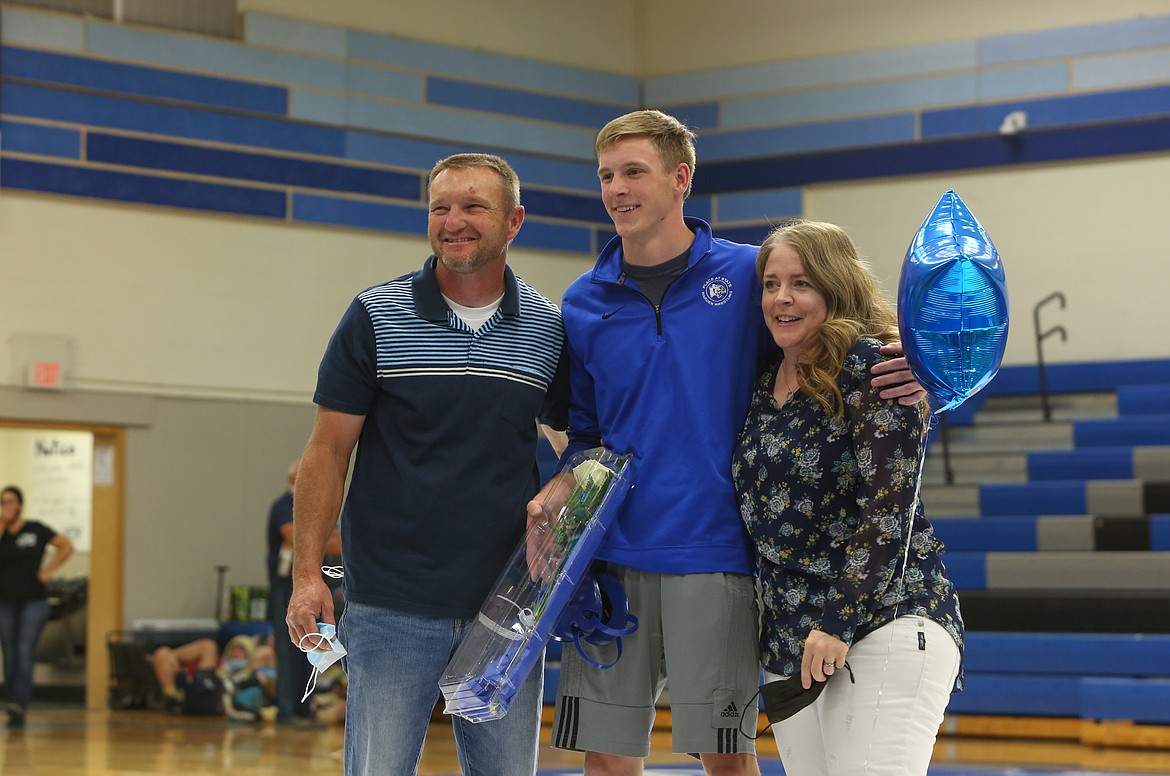 Warden High School senior Brenton Cole is honored with his parents before his first and only home dual this season on Saturday afternoon in Warden.