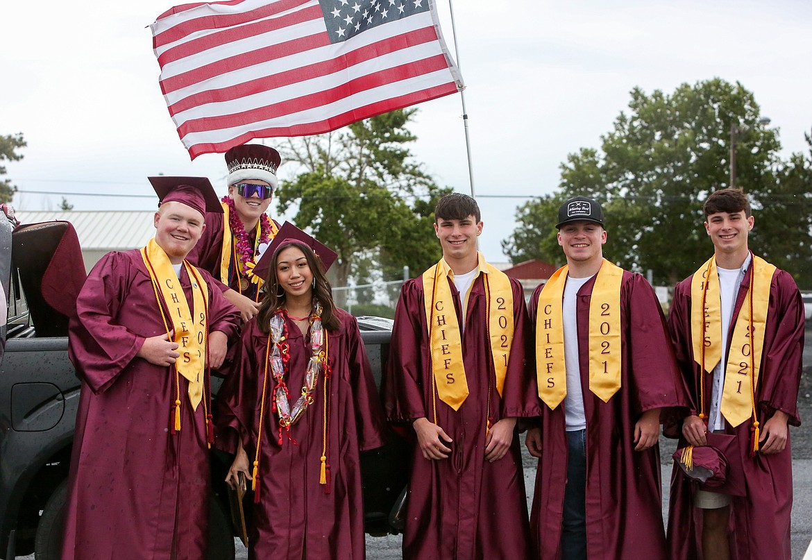 A group of 2021 Moses Lake High School graduates gather together for a photo before the graduation parade ceremony kicks off Friday afternoon, June 11, at the Grant County Fairgrounds.