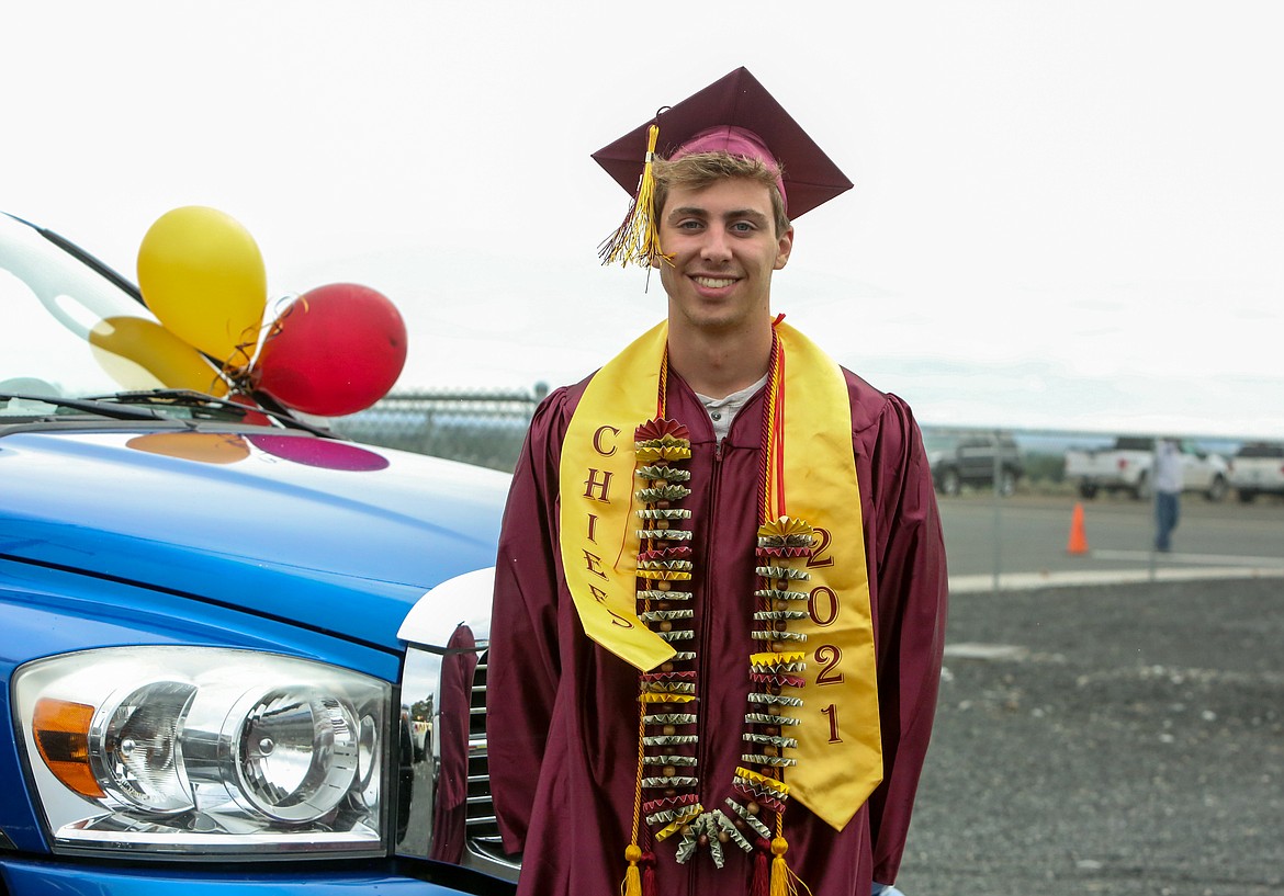 Graduating senior Zach Washburn stops for a photo before the graduation parade ceremony kicks off for Moses Lake High School Friday afternoon at the Grant County Fairgrounds.