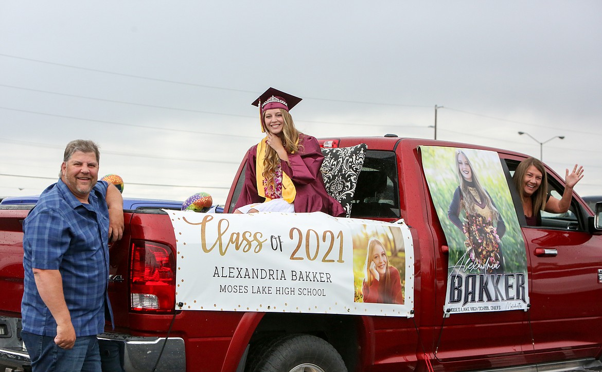 2021 Moses Lake High School graduate Alexandria Bakker and her family take a momentary break from decorating their vehicle for a photo Friday afternoon at the Grant County Fairgrounds.