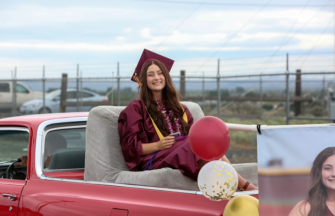 Moses Lake High School graduate Lacey Moser smiles as she heads off in the 2021 graduation parade ceremony down Airway Drive Northeast on Friday afternoon, June 11.