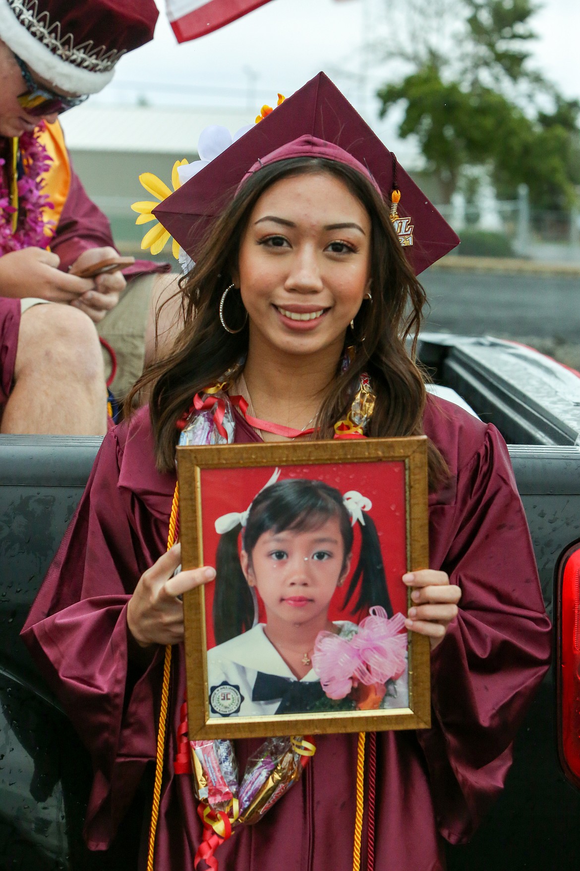 2021 Moses Lake High School graduate Chebe Yen Gesulga holds up a photo of herself as a child before Friday’s graduation ceremony as she celebrates being a part of this year’s graduating class at MLHS.