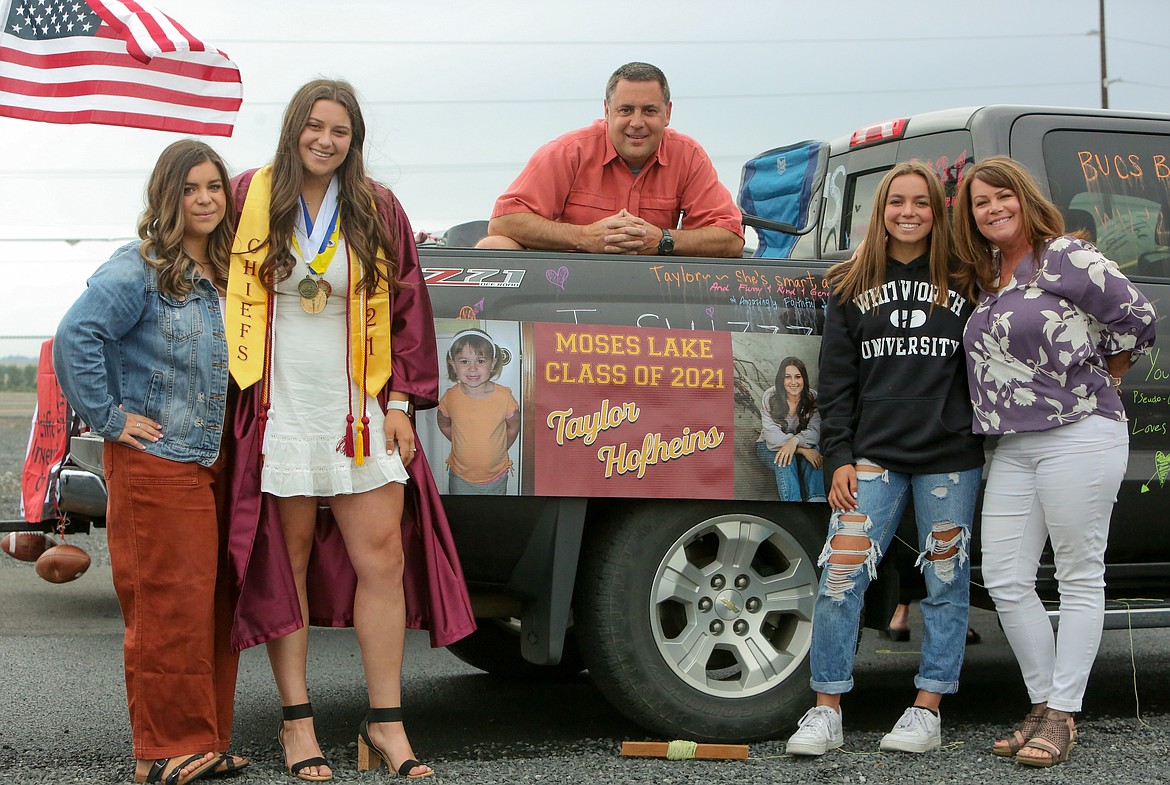 Moses Lake High School senior Taylor Hofheins poses with her family before the graduation parade ceremony kicks off on Friday afternoon, June 11, at the Grant County Fairgrounds.
