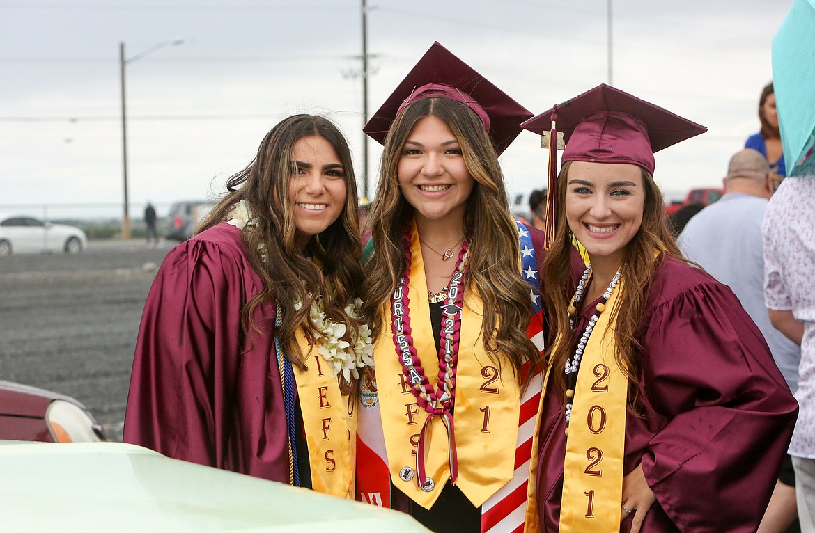 Left to right, Madi Olson, Laurissa Martinez and Ciarrah Knoll pose together for a photo before the graduation parade at the Grant County Fairgrounds on Friday, June 11.