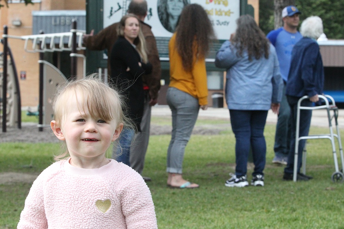 Everly Graham stands in front of the Judy Graham Memorial Playground at the Libby Elementary School. Family members and friends met to dedicate the playground on June 12. (Will Langhorne/The Western News)