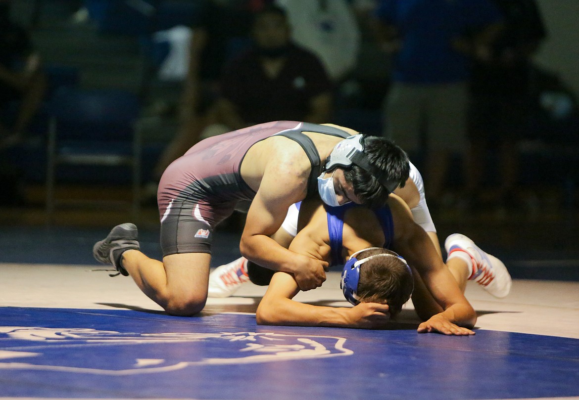 Wahluke High School's Salvador Alvalos looks to gain position against his opponent from Warden, Angel Cruz, on Saturday afternoon at Warden High School.