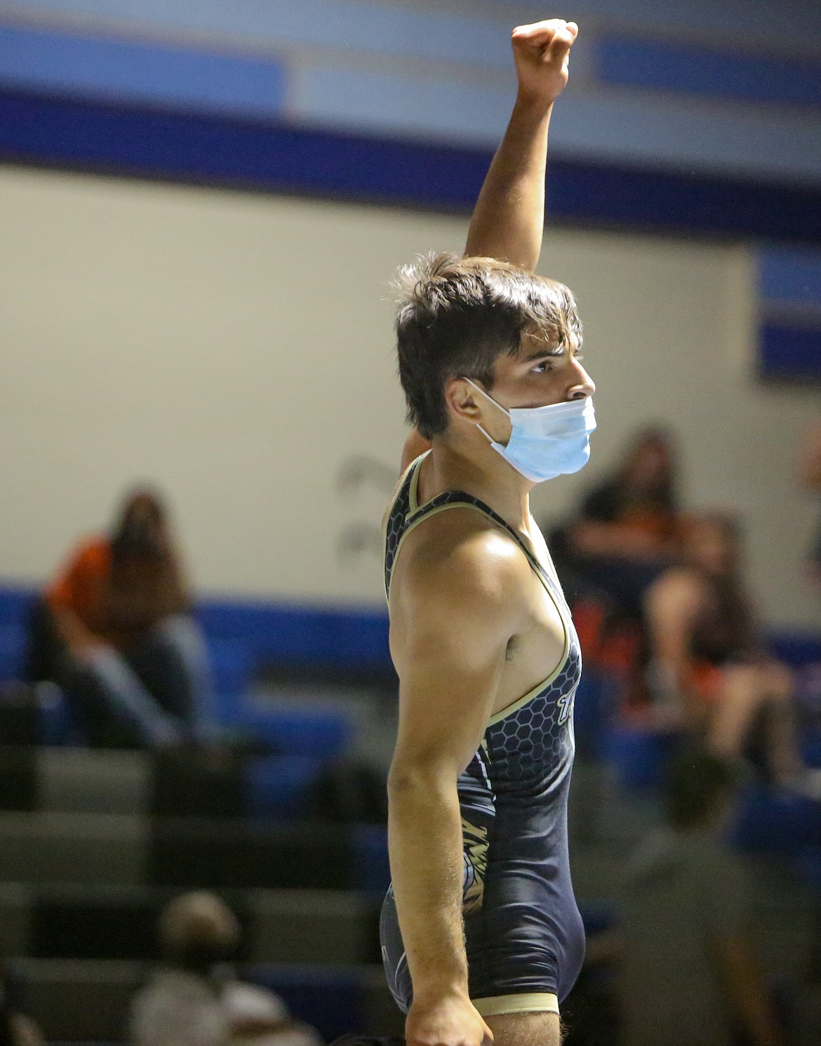 Royal High School senior Dominic Martinez holds his hand high after winning his match against Wahluke High School's Sergio Tapia on Saturday afternoon in Warden.
