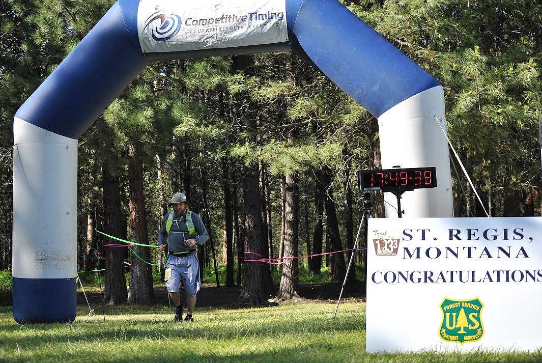 Superior resident Derek Larson crosses the finish line at the St. Regis Park just before 6 p.m. Saturday after starting his first 50-mile race in Mullan, Idaho at 7 a.m. Larson is the music teacher for both of these communities and used his racing experience as a means of raising funds for both of his music departments. (Amy Quinlivan/Mineral Independent)