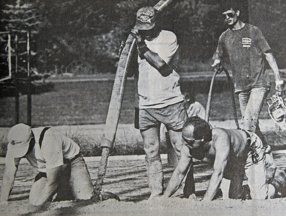 Ken Sebrowsky (bottom right) helps fellow volunteers pour concrete for the Mountain Trails Ice Rink in July 1992. (Pilot file)