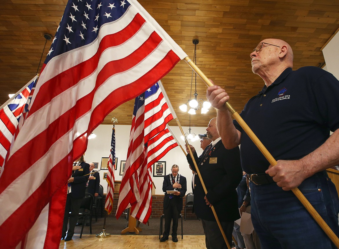 Karl Fousek holds a flag at the Coeur d'Alene Elks Lodge on Monday during a Flag Day ceremony.
