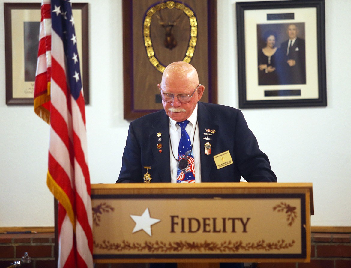 Narrator Rick Alexander reads the history of the flag on Monday,