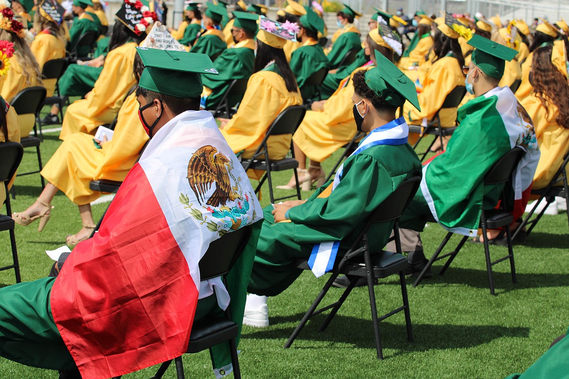 Students don the Mexican flag at Quincy High School’s Saturday commencement.