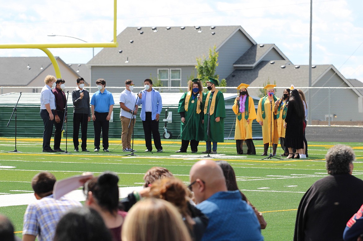 Parents watch as Quincy High School’s Spectrum Choir sings “Rise Up” at Saturday’s commencement.