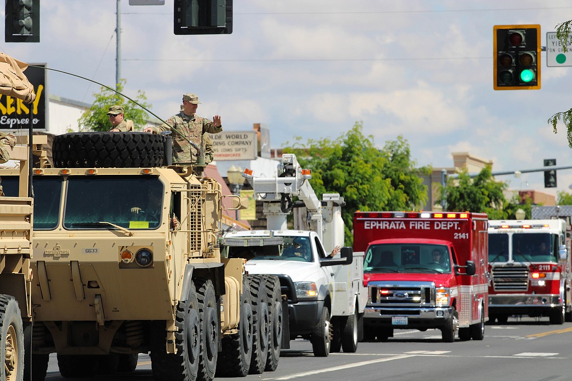 Army National Guard members wave at Saturday’s Sage-N-Sun parade in Ephrata.