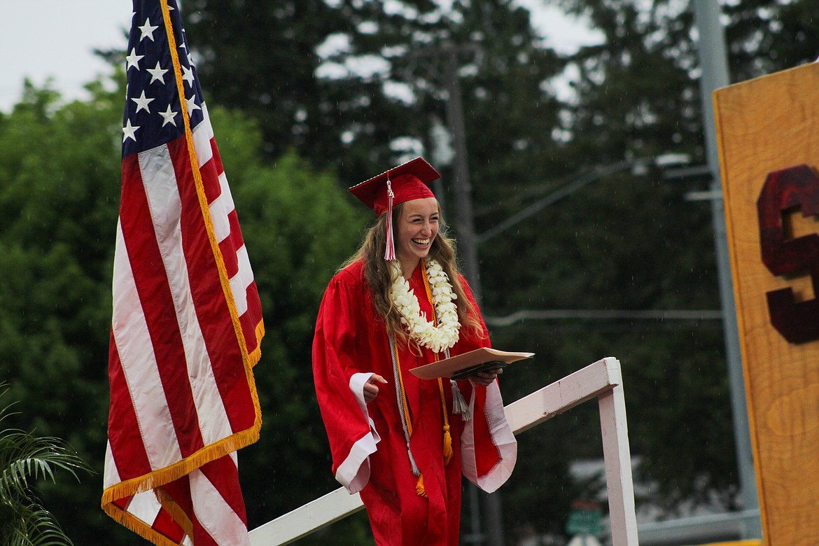 Valedictorian Camille Neuder walks to the stage Friday at War Memorial Field.