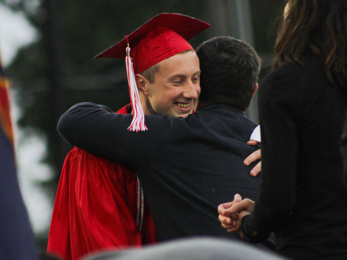 A student hugs Lonnie Williams, trustee for the Lake Pend Oreille School District, Friday at War Memorial Field.