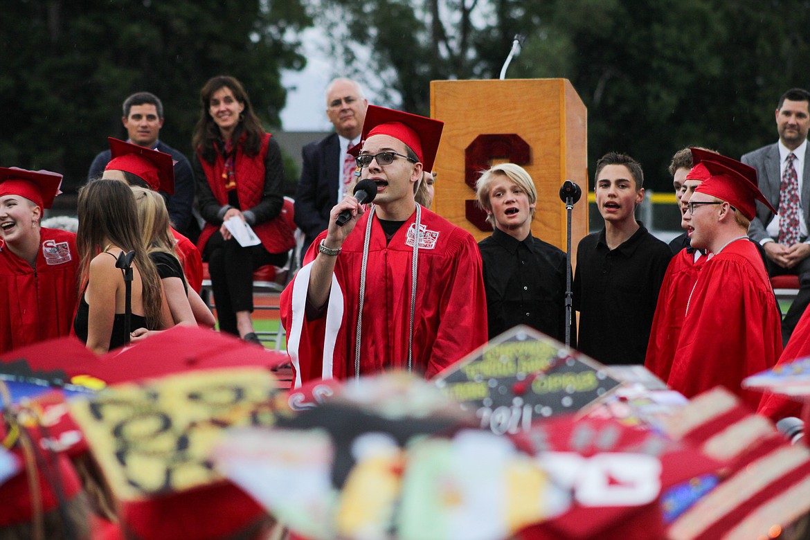 Trustees for the Lake Pend Oreille School District, Lonnie Williams and Geraldine Lewis, along with Superintendent Tom Albertson and Principal David Miles, look on as the choir performs “I’ll Always Remember You” Friday at War Memorial Field.