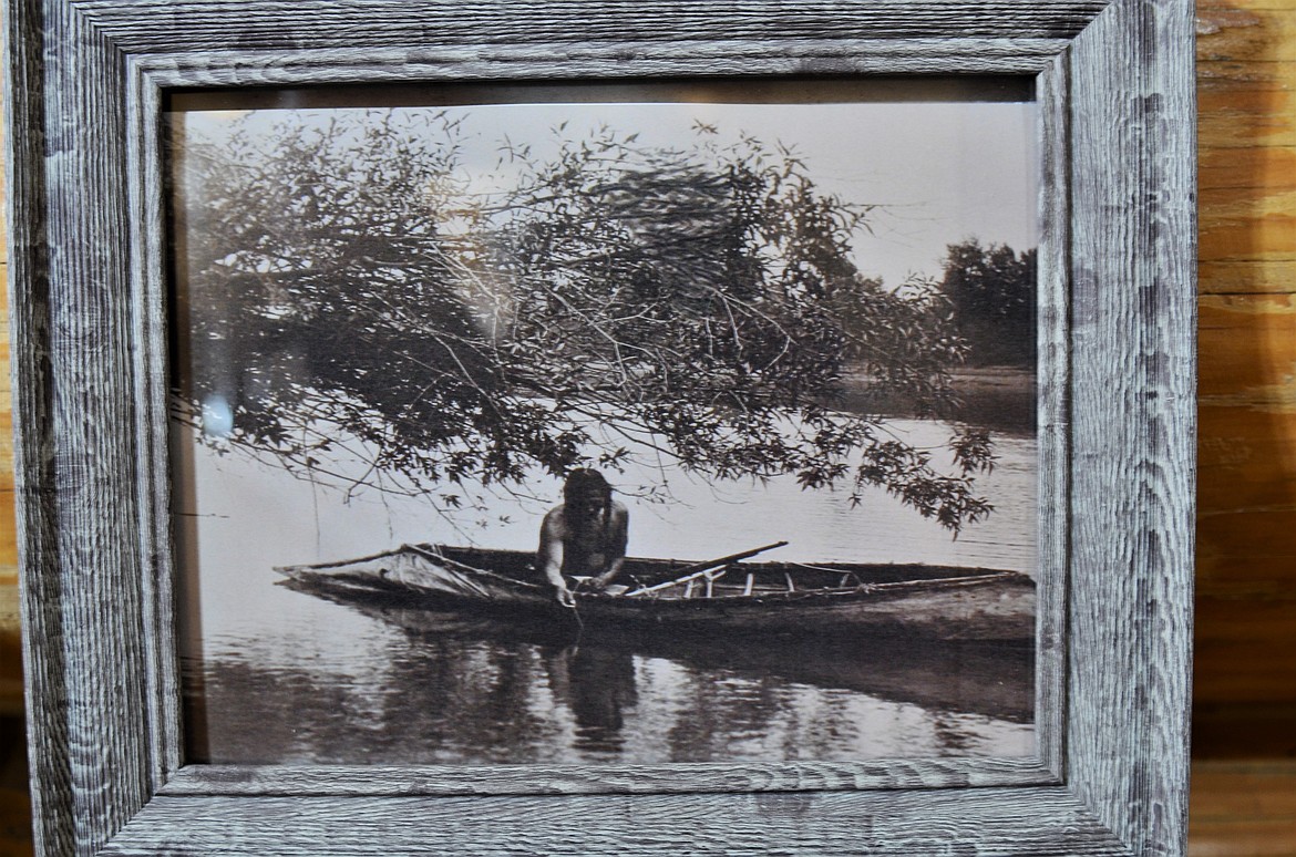 This photo of a Kootenai fisherman in a sturgeon-nosed canoe survived the fire. (Carolyn Hidy/Lake County Leader)