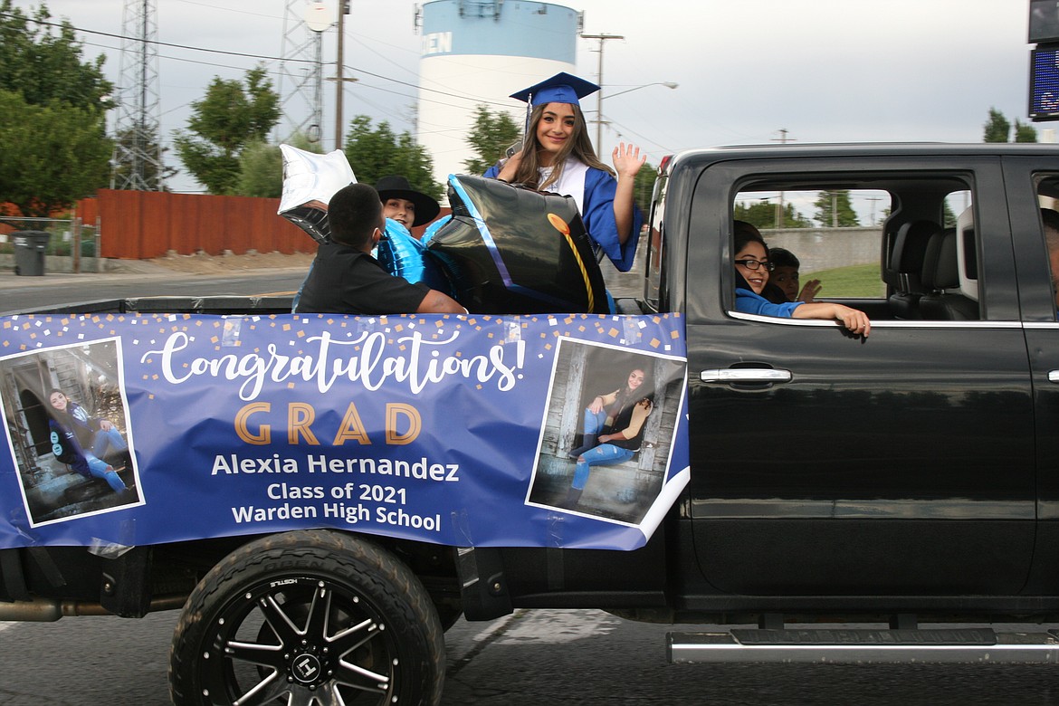 A Warden High School graduate enters the school grounds during the car parade before the ceremony June 11.