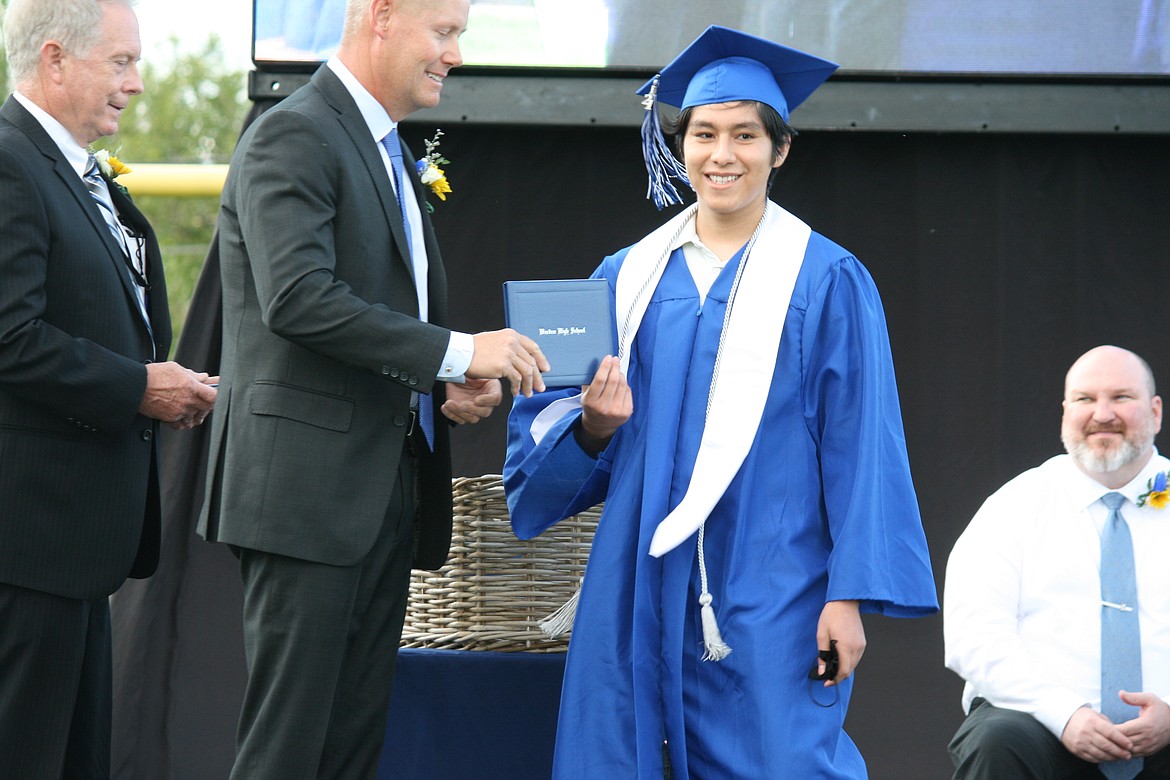 A Warden High School graduate receives his diploma in ceremonies June 11.