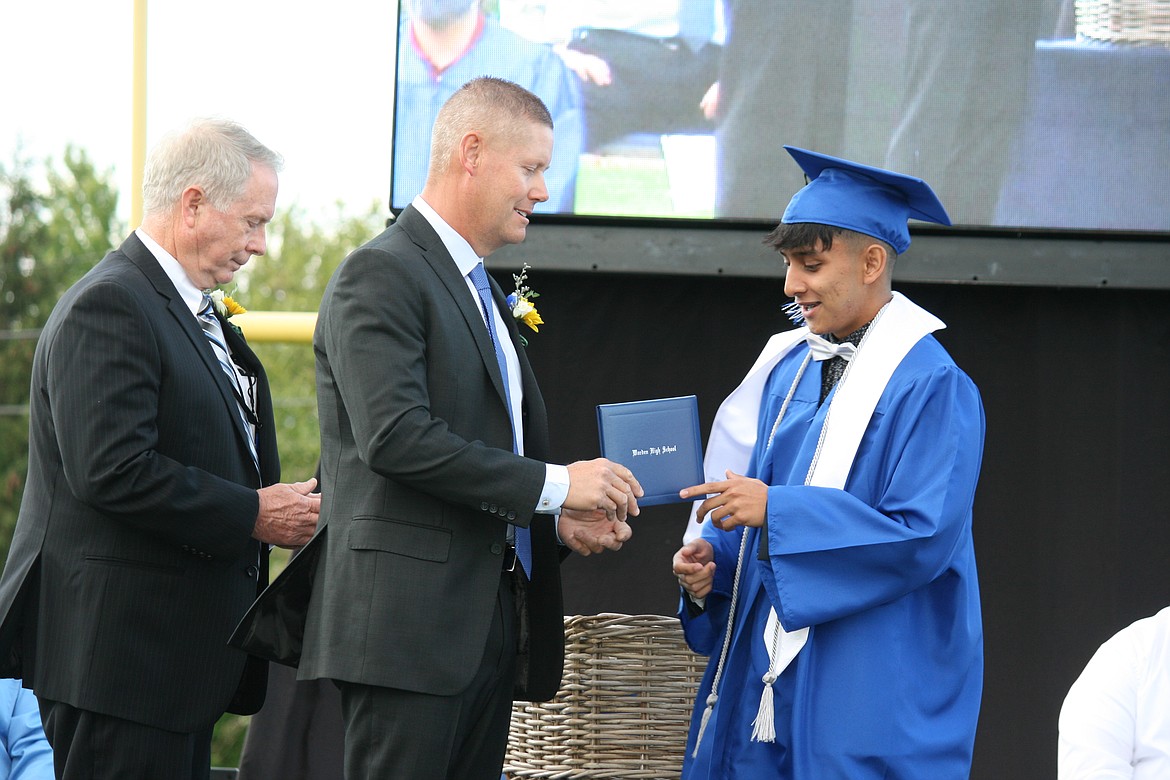 A Warden High School senior receives his diploma during graduation ceremonies June 11.