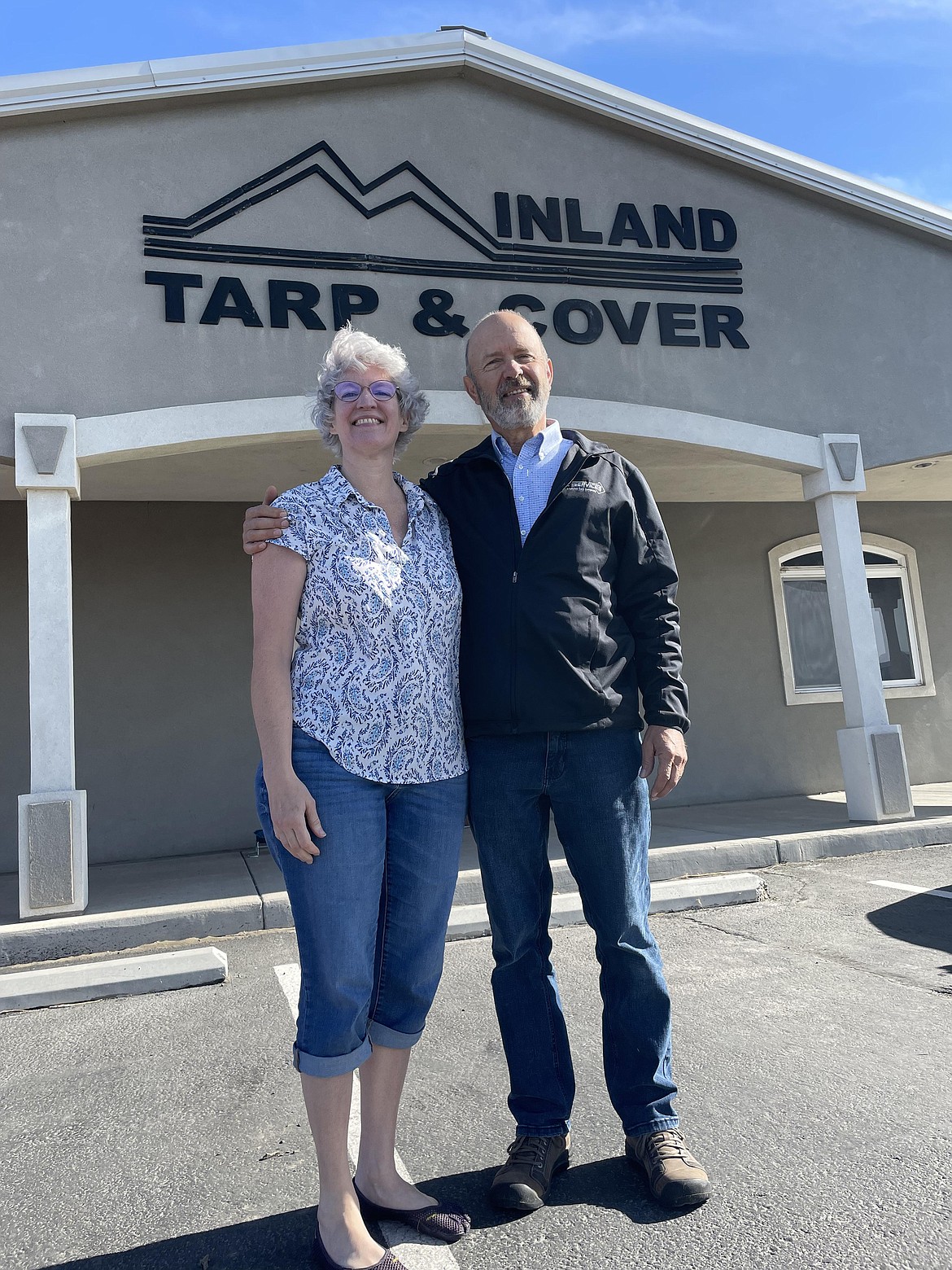 Carol and Glen Knopp outside the administrative offices of Inland Tarp and Cover. The company founder, Glen has set up a trust to give employees shares in the company.