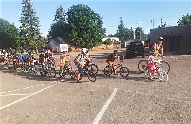 Teachers and parents, with an assist from local police, recently put together a "ride to and from school" event. The group rode from The Shoe across the bridge (with police escort) to school. There were two other groups that started at other points, Grenier Lane/Kerr Dam bike path and the Century 21 parking lot. (Courtesy of Sheri Connors-David)