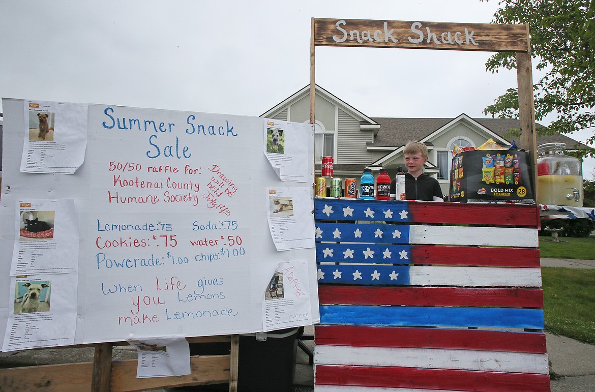 Kertin Saunders, 9, is seen here Tuesday behind his homemade Snack Shack, where he'll work three days a week for five weeks this summer. He is also hosting a 50/50 raffle to raise money for the Kootenai Humane Society. The raffle winner will be announced July 14.