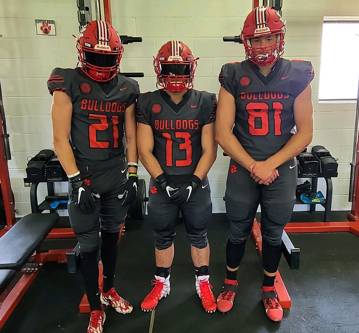 Players show off the new anthracite-colored alternate uniforms the football team will wear this fall to honor the history of the program.