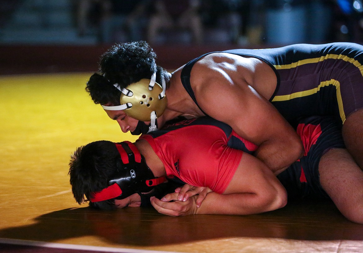 Moses Lake High School senior Cruz Vasquez holds his opponent down on the mat before picking up the technical fall victory on Tuesday night in the final home dual of the season for the Chiefs.
