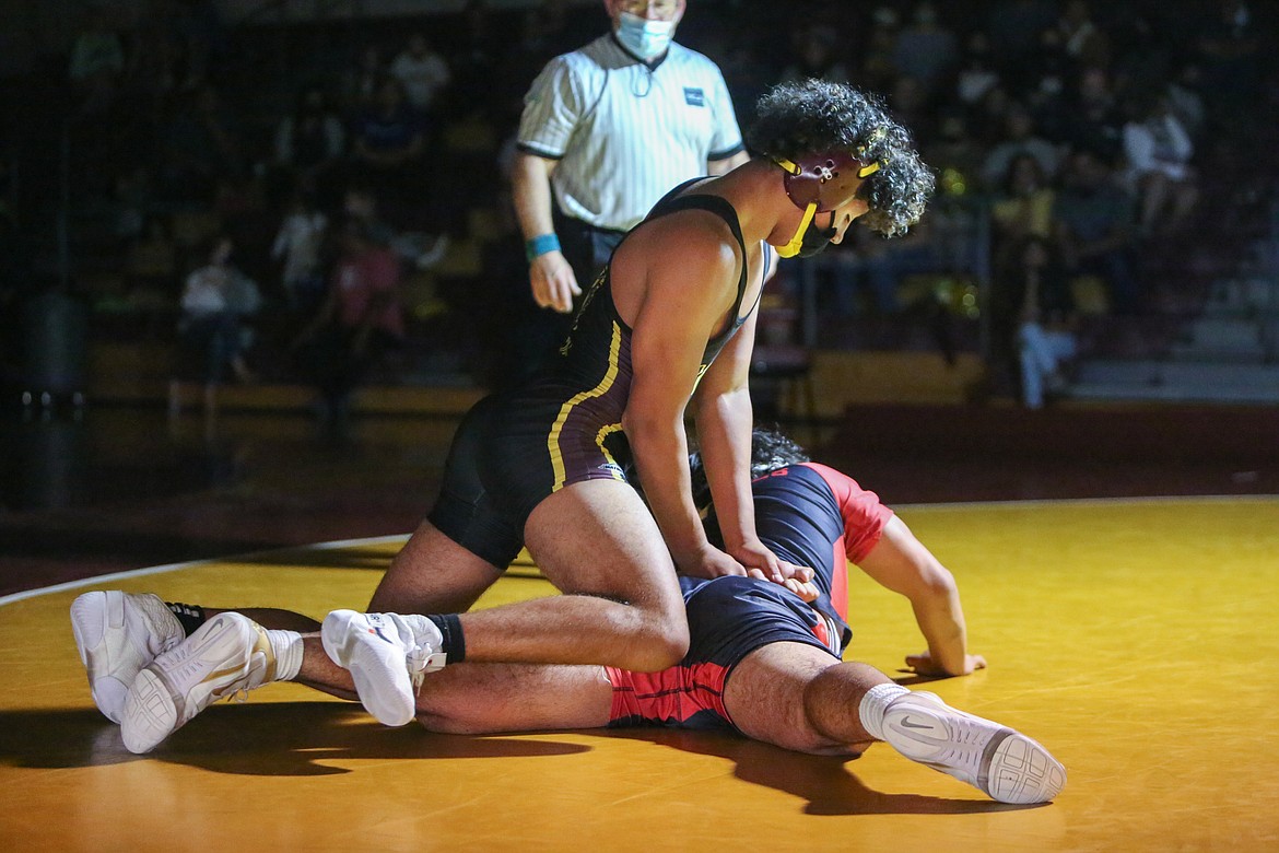 Moses Lake High School senior Maximus Zamora holds his opponent in place on the mat while looking to gain position in his final home dual as a Chief on Tuesday night in the Chiefs Gym.