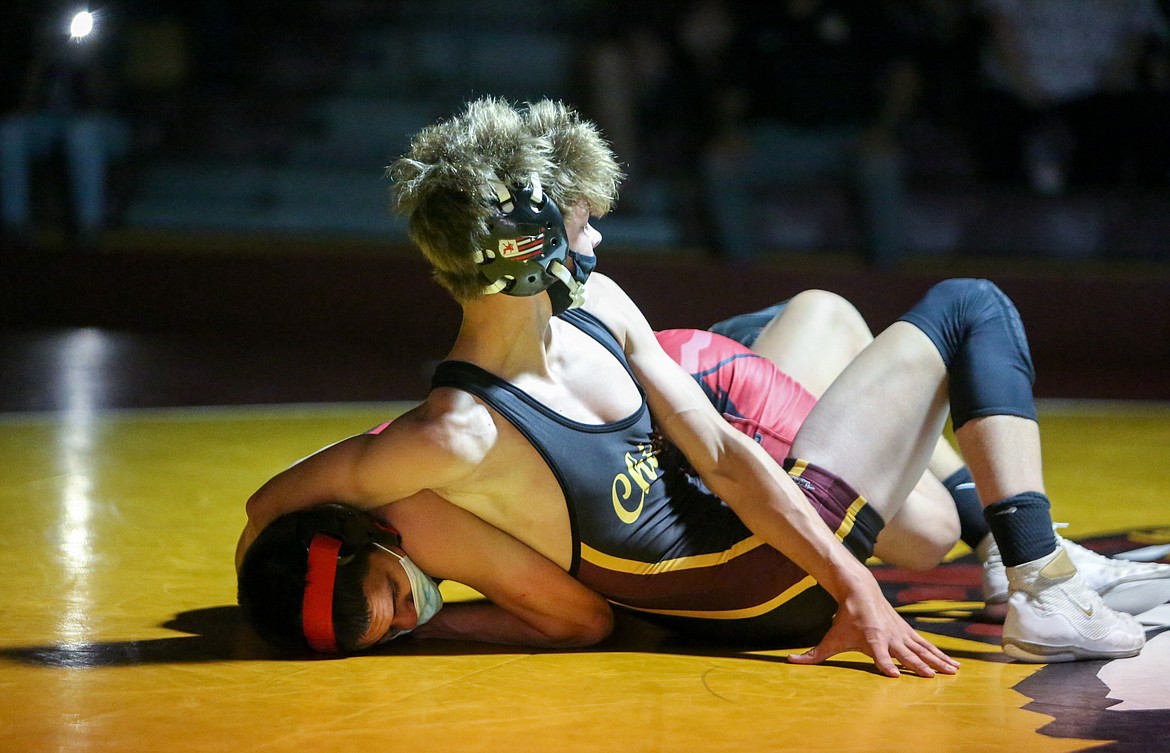 Moses Lake freshman Dayton Regan checks the time late in the round in the opening bout of the evening on Tuesday night against Sunnyside High School in Moses Lake.
