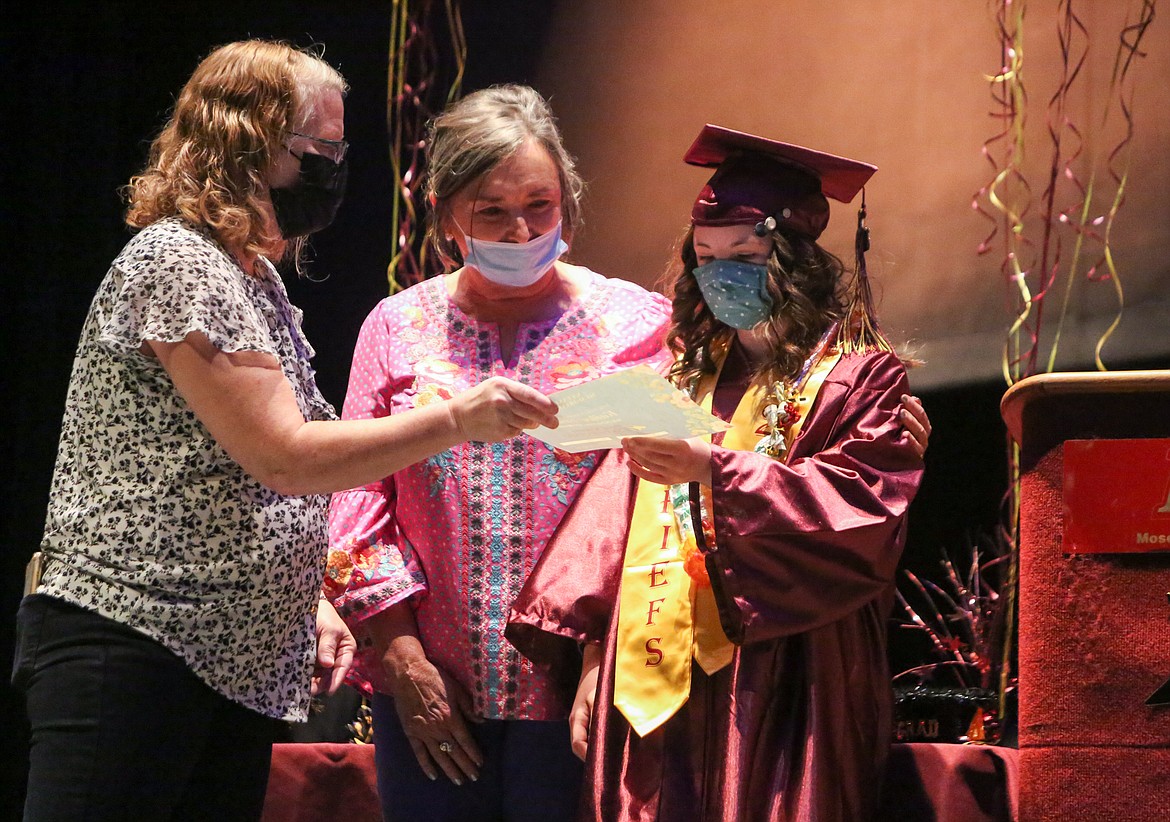 Left to right, Denise Ketola and Pam Hare with the Down Syndrome Society of Grant County award Kailee Truman the Natasha Hastings Memorial scholarship fund at the graduation ceremony on Wednesday afternoon at Moses Lake High School.