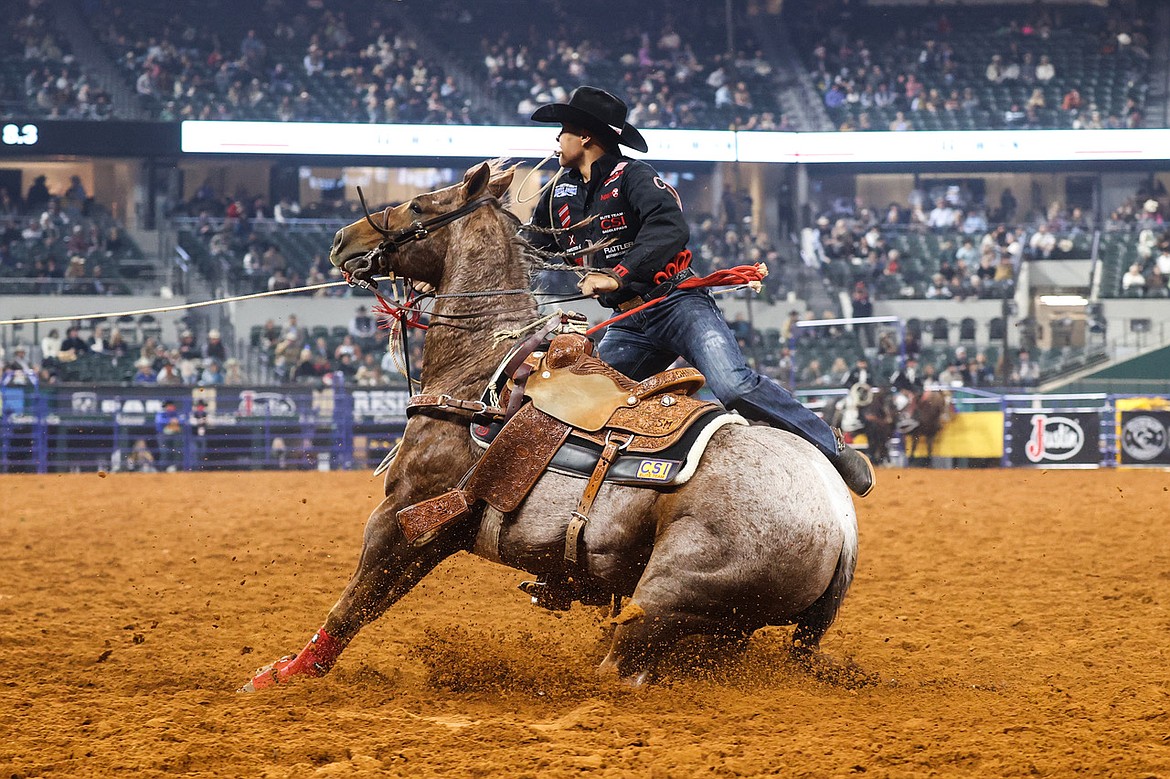 Tie-down roping contestant Shad Mayfield reels in the livestock during an event at the 2020 PRCA National Finals Rodeo in Arlington, Texas.