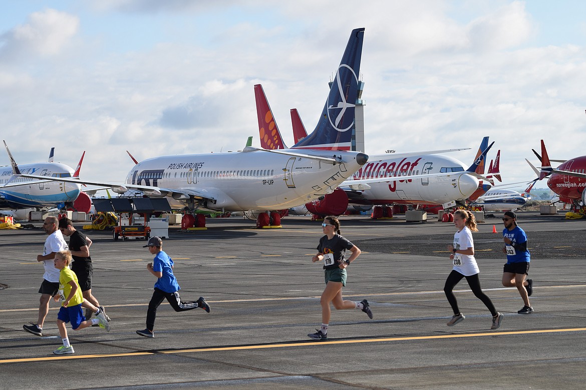 Runners jog down the taxiway at the Grant County International Airport early Saturday, during the Runway 5K/10K, which allowed participants to run down the airport’s 13,500-foot-long main runway.