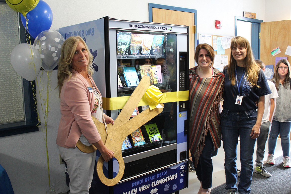 (Photo by Victor Corral Martinez)
Patti Solt, Rebekah Johnson and Julie Colsen unveiling the book vending machine