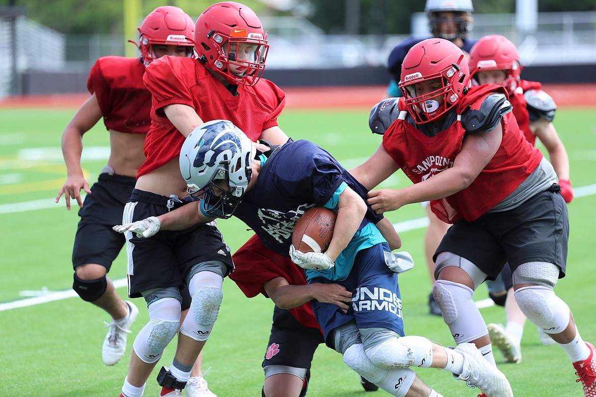 Junior varsity players swarm to tackle a Lake City running back on Wednesday.