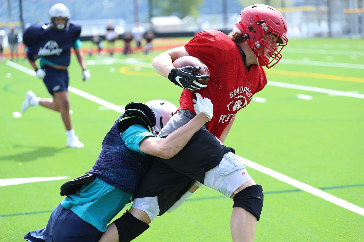 Running back Owen Wimmer drags a Lake City defender with him as he tries to fight through a tackle and head upfield on Wednesday.