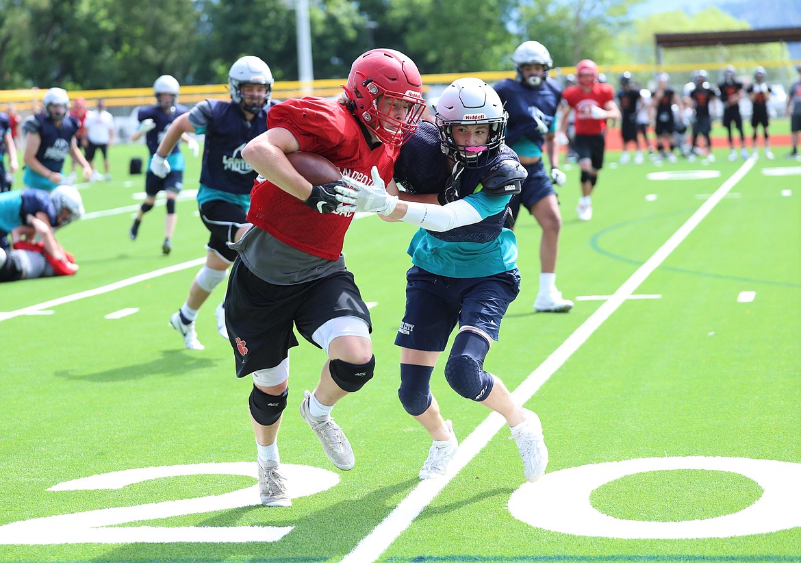 Owen Wimmer stiff arms a Lake City defender on Wednesday.