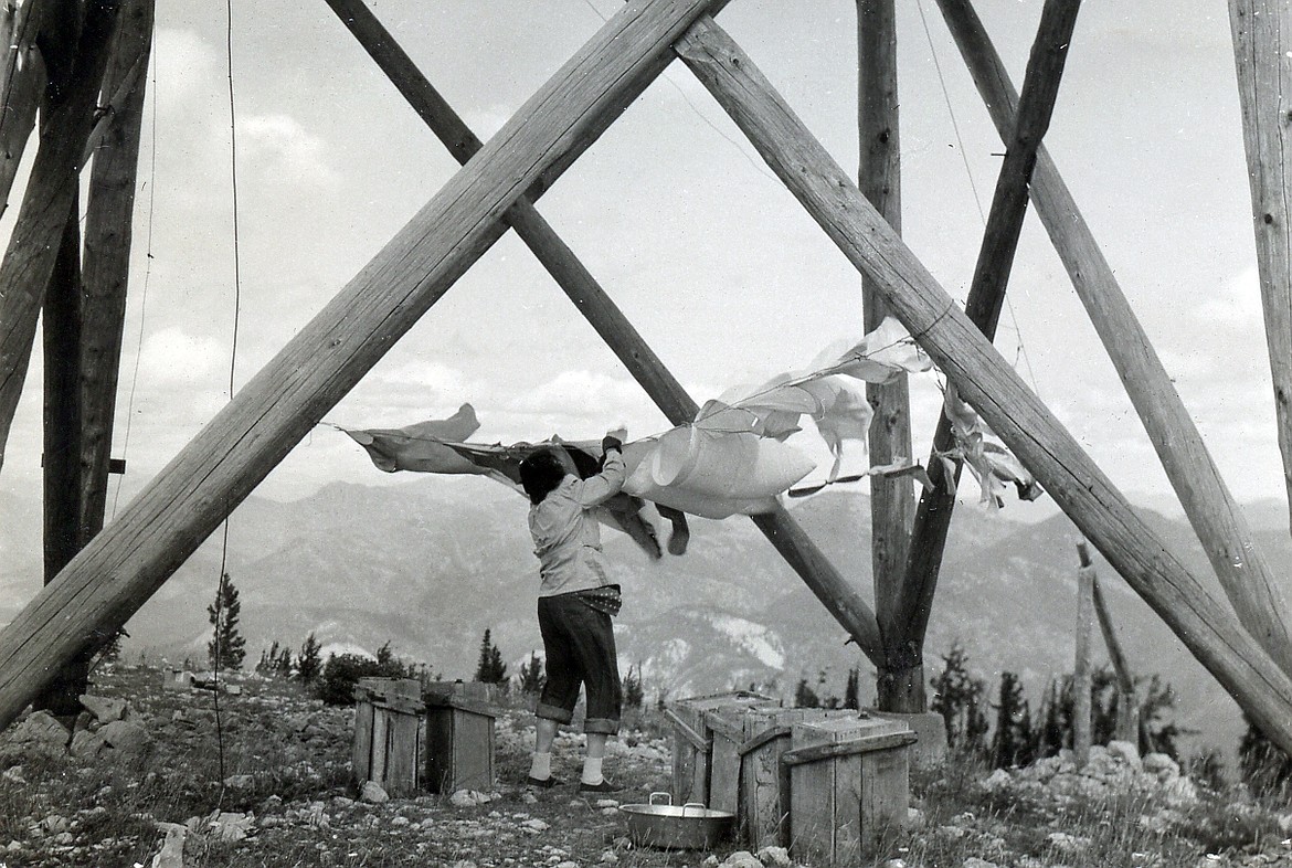 Rebecca McNees Osborn hangs the laundry out to dry beneath the Spotted Bear Lookout during the summer of 1948. (Joe Osborn photo)